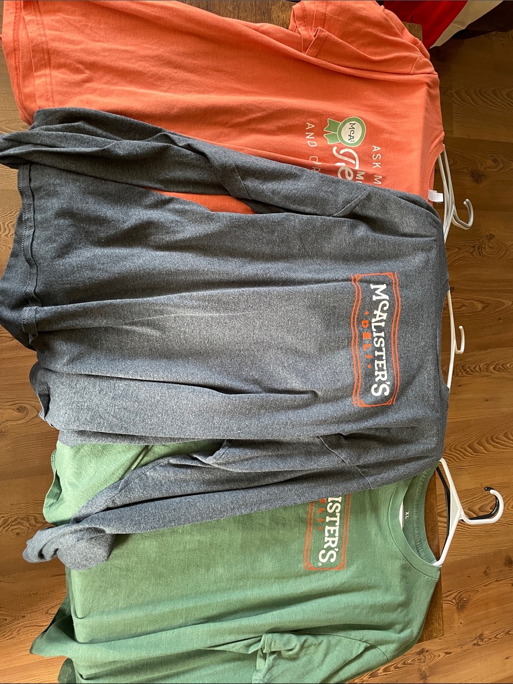 5 McAlisters shirts including 1 long sleeve and 4 short sleeve t-shirts.